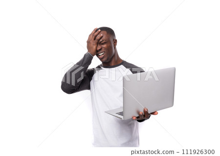 young african man working remotely in IT field and holding nuotbook on white background young african man working remotely in IT field and holding nuotbook on white background 111926300