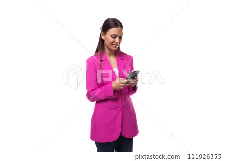 young slender brunette secretary woman wearing a lilac jacket uses a smartphone young slender brunette secretary woman wearing a lilac jacket uses a smartphone 111926355