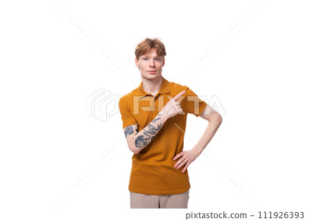 young slender caucasian man with red short hair and a tattoo on his arm is dressed in a yellow t 111926393