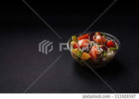 Delicious juicy salad with salmon, tomatoes, cucumber, herbs, pumpkin seeds, salt and spices Delicious juicy salad with salmon, tomatoes, cucumber, herbs, pumpkin seeds, salt and spices 111926597