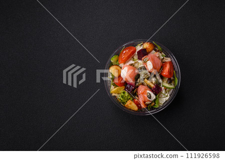 Delicious juicy salad with salmon, tomatoes, cucumber, herbs, pumpkin seeds, salt and spices Delicious juicy salad with salmon, tomatoes, cucumber, herbs, pumpkin seeds, salt and spices 111926598