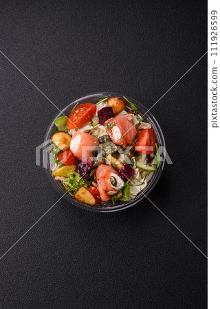 Delicious juicy salad with salmon, tomatoes, cucumber, herbs, pumpkin seeds, salt and spices 111926599