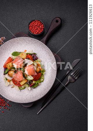 Delicious juicy salad with salmon, tomatoes, cucumber, herbs, pumpkin seeds, salt and spices 111926613