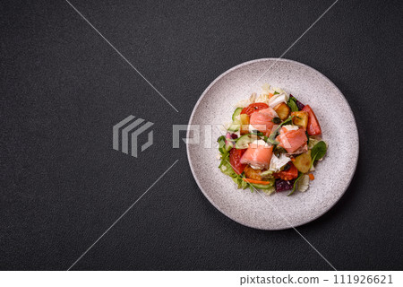 Delicious juicy salad with salmon, tomatoes, cucumber, herbs, pumpkin seeds, salt and spices 111926621