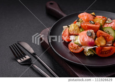Delicious juicy salad with salmon, tomatoes, cucumber, herbs, pumpkin seeds, salt and spices 111926629