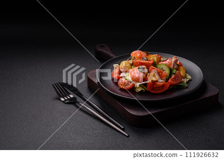 Delicious juicy salad with salmon, tomatoes, cucumber, herbs, pumpkin seeds, salt and spices 111926632