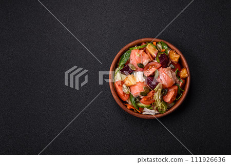 Delicious juicy salad with salmon, tomatoes, cucumber, herbs, pumpkin seeds, salt and spices Delicious juicy salad with salmon, tomatoes, cucumber, herbs, pumpkin seeds, salt and spices 111926636