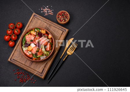Delicious juicy salad with salmon, tomatoes, cucumber, herbs, pumpkin seeds, salt and spices 111926645