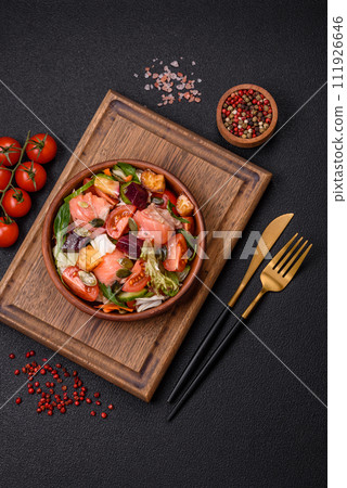 Delicious juicy salad with salmon, tomatoes, cucumber, herbs, pumpkin seeds, salt and spices Delicious juicy salad with salmon, tomatoes, cucumber, herbs, pumpkin seeds, salt and spices 111926646