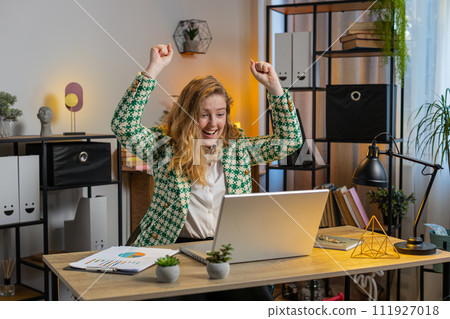 Business woman working on laptop victory, game winning lottery goal achievement, good career news Business woman working on laptop victory, game winning lottery goal achievement, good career news 111927018