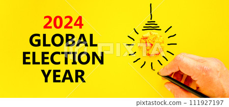 2024 global election year symbol. Concept words 2024 global election year on beautiful yellow paper. Beautiful yellow background. Voter hand. Business 2024 global election year concept. Copy space 2024 global election year symbol. Concept words 2024 global election year on beautiful yellow paper. Beautiful yellow background. Voter hand. Business 2024 global election year concept. Copy space 111927197