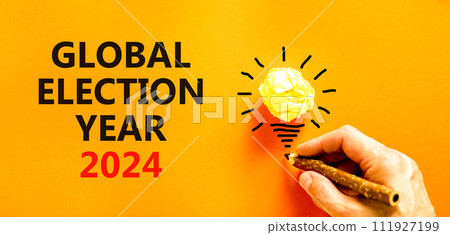 Global election year 2024 symbol. Concept words Global election year 2024 on beautiful orange paper. Beautiful orange background. Voter hand. Business Global election year 2024 concept. Copy space Global election year 2024 symbol. Concept words Global election year 2024 on beautiful orange paper. Beautiful orange background. Voter hand. Business Global election year 2024 concept. Copy space 111927199