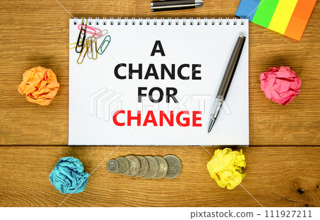 A chance for change symbol. Concept words A chance for change on beautiful white note. Beautiful wooden table background. Colored paper. Black pen. Business A chance for change concept. Copy space. 111927211