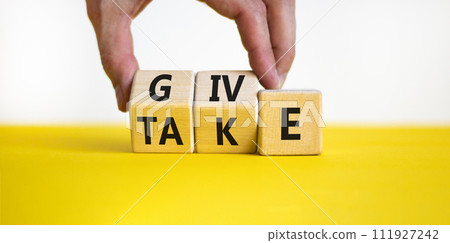 Give or take symbol. Concept word Give or Take on wooden cubes. Beautiful yellow table white background. Businessman hand. Business give or take concept. Copy space. Give or take symbol. Concept word Give or Take on wooden cubes. Beautiful yellow table white background. Businessman hand. Business give or take concept. Copy space. 111927242