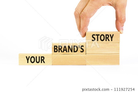 Branding and your brand story symbol. Concept words Your brands story on beautiful wooden blocks. Beautiful white background. Businessman hand. Business branding your brand story concept. Copy space. 111927254