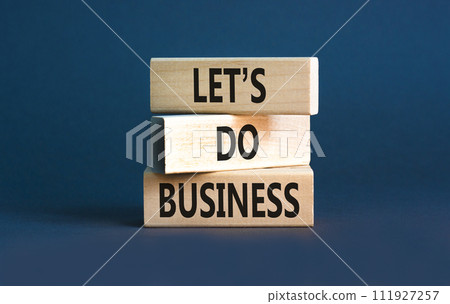 let is do business symbol. Concept words let is do business on beautiful wooden blocks. Beautiful grey table grey background. let is do business concept. Copy space. 111927257