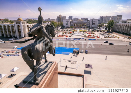 Aerial top view to Monument Epic Statue of Aykol Manas - kyrgyz hero on Ala-Too Square. State History Museum in downtown of Bishkek city. Central asia, Kyrgyzstan. 111927740
