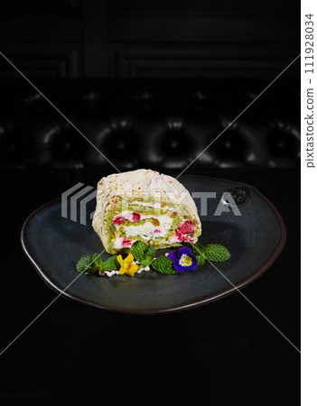 Meringue roll with raspberries and pistachios Meringue roll with raspberries and pistachios 111928034