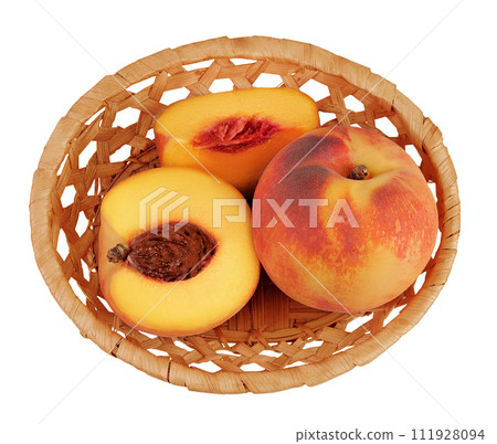Ripe peach fruit with half in a wicker basket isolated on white background with full depth of field. Top view. Flat lay Ripe peach fruit with half in a wicker basket isolated on white background with full depth of field. Top view. Flat lay 111928094
