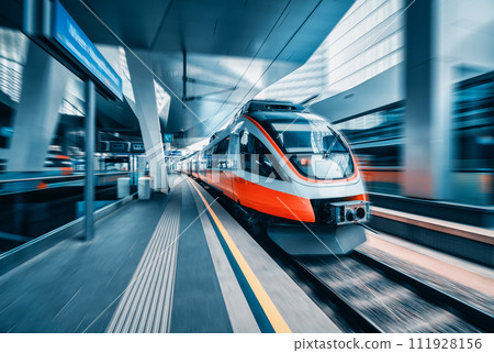High speed train in motion at modern railway station High speed train in motion at modern railway station 111928156