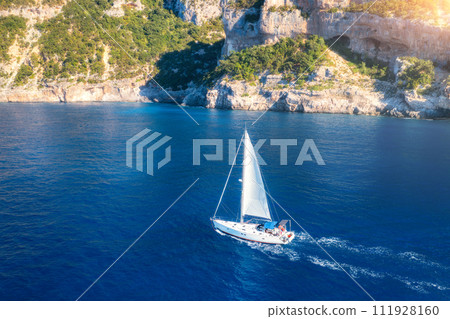 Aerial view of sailboat on blue sea at sunrise in summer. Travel 111928160