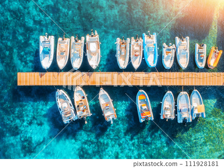 Aerial view of boats and yachts in dock at sunset in summer 111928181