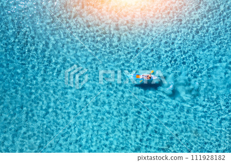Aerial view of kayak with people in blue sea at sunset. Travel 111928182