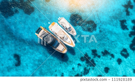 Aerial view of luxury yachts and boats on blue sea at sunset 111928189