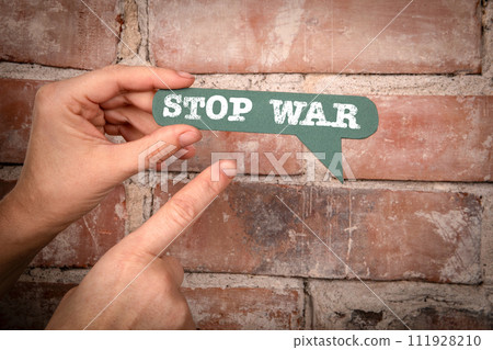 Stop War. Green speech bubble with text on a red brick background Stop War. Green speech bubble with text on a red brick background 111928210