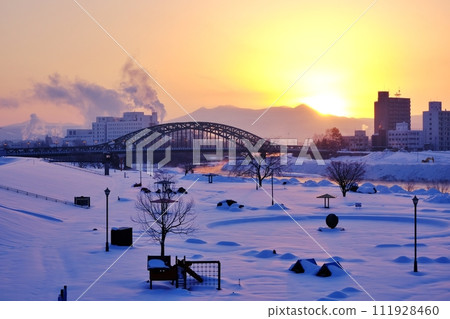 Sunrise over Asahi Bridge and Daisetsuzan Mountain Range, Asahikawa City, Hokkaido Sunrise over Asahi Bridge and Daisetsuzan Mountain Range, Asahikawa City, Hokkaido 111928460