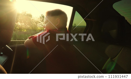 child hand touches sun, warm sun illuminates fingers, boy sitting car waves hand through window, child kid extends hand from car window, catching wind adventure sunset., child reaches out his hand child hand touches sun, warm sun illuminates fingers, boy sitting car waves hand through window, child kid extends hand from car window, catching wind adventure sunset., child reaches out his hand 111931447