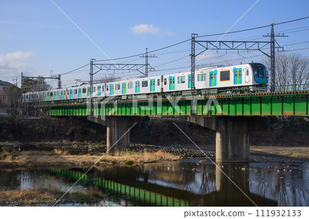 Seibu Ikebukuro Line express train passing the Irumagawa Bridge Seibu Ikebukuro Line express train passing the Irumagawa Bridge 111932133