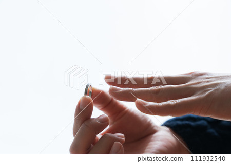 Photo of hand removing ring 111932540