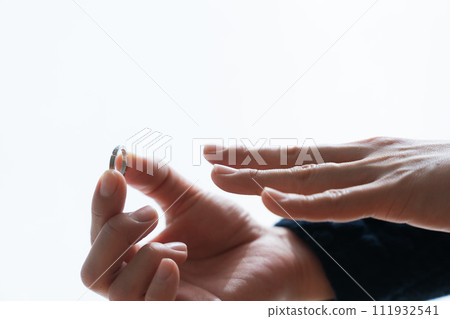 Photo of hand removing ring Photo of hand removing ring 111932541