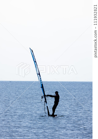 Windsurfing around the water in the refreshing breeze 111932821