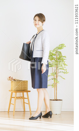 Full body of a woman wearing a ceremony suit (fashion coordination) Full body of a woman wearing a ceremony suit (fashion coordination) 111933621
