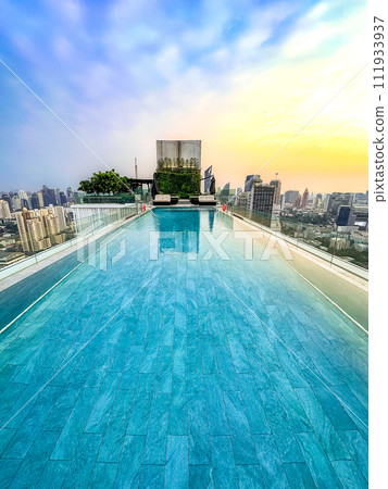 Rooftop pool with Bangkok skyline view at sunset, in Bangkok Thailand Rooftop pool with Bangkok skyline view at sunset, in Bangkok Thailand 111933937