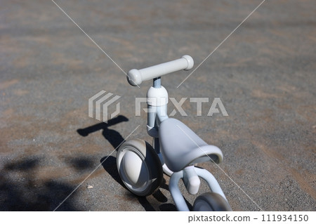 A stylish white tricycle in the park 111934150