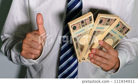 Businessman holding a lot of money and posing Businessman holding a lot of money and posing 111934911