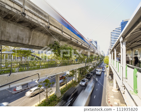 Cars and skytrain running on Sukhumvit Road, Bangkok, Thailand / Bangkok, Thailand 111935820
