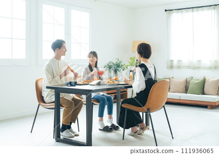 Parent and child smiling around the table 111936065