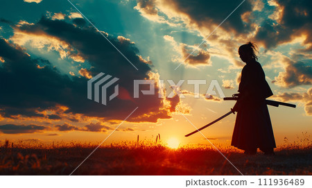 A samurai holding a sword against the setting sun 111936489