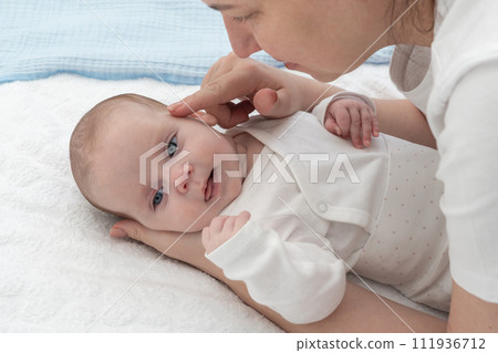 Mom plays with newborn baby and baby is happy 111936712