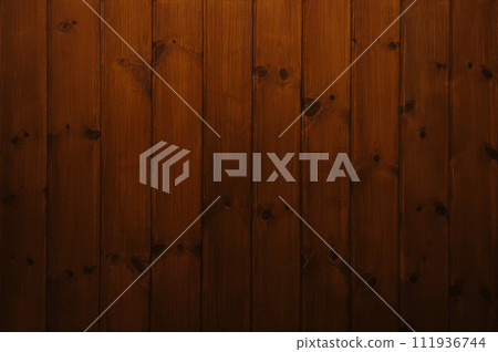 Background image of a vertical plank wall with dark brown wood grain and knotty varnished paneling Background image of a vertical plank wall with dark brown wood grain and knotty varnished paneling 111936744