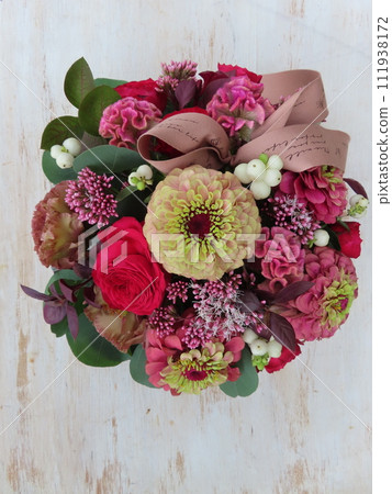 Autumn minimal arrangement centered around zinnias 111938172