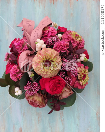 Autumn minimal arrangement centered around zinnias 111938173
