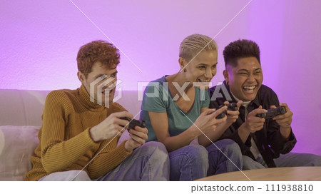 Excited multiethnic friends playing console at home 111938810