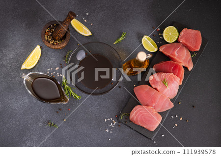 Pieces of Fresh tuna Fish fillet and soy sauce marinade in a glass bowl Pieces of Fresh tuna Fish fillet and soy sauce marinade in a glass bowl 111939578