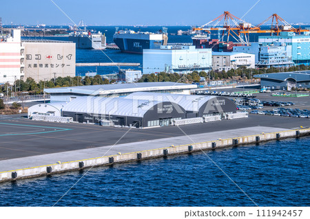 Yokohama cityscape in Japan View of Daikoku Pier passenger ship terminal and car carrier (back) (Aqua Line on the sea) Yokohama cityscape in Japan View of Daikoku Pier passenger ship terminal and car carrier (back) (Aqua Line on the sea) 111942457