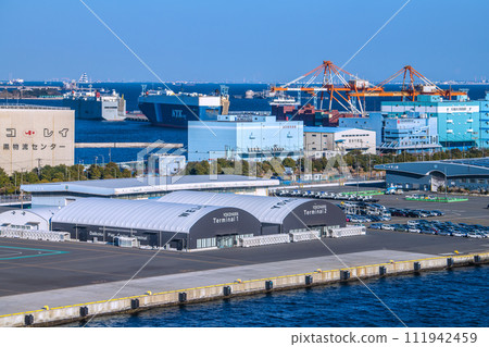 Yokohama cityscape in Japan View of Daikoku Pier passenger ship terminal and car carrier (back) (Aqua Line on the sea) Yokohama cityscape in Japan View of Daikoku Pier passenger ship terminal and car carrier (back) (Aqua Line on the sea) 111942459